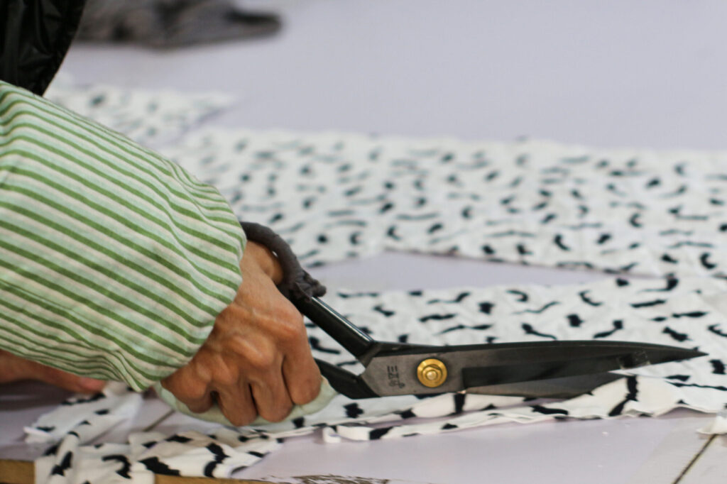 Cutting the fabric pieces by the paper templates.